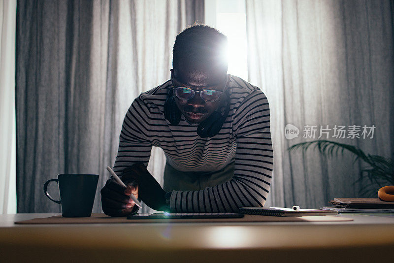 Handsome BusinessmanÂ Working At Home On A Digital Tablet